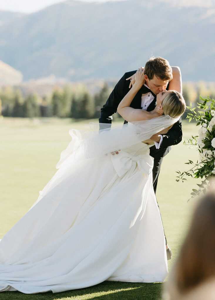 bride-groom-kiss-gown-white-destination-wedding-white-romantic