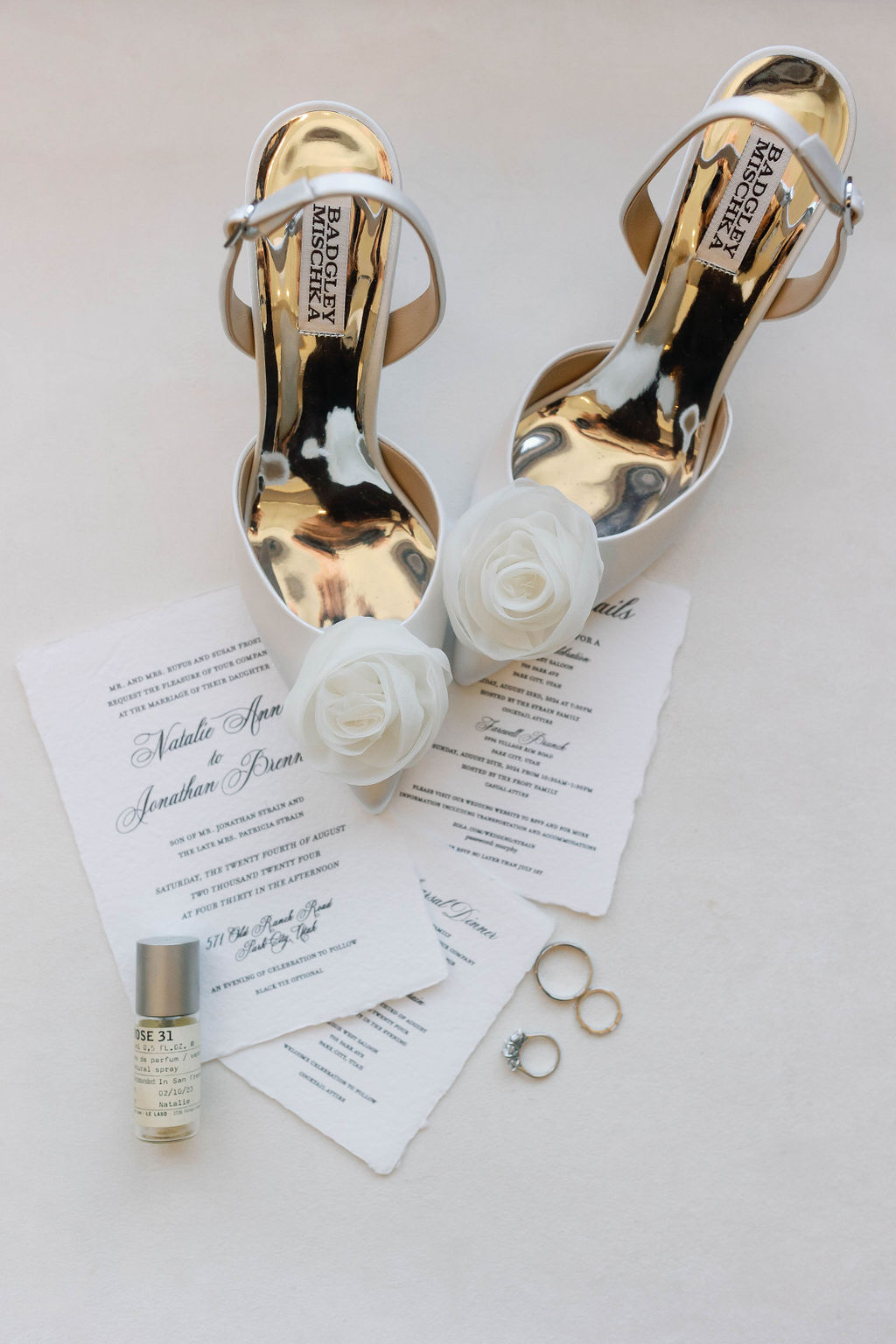 Badgley Mischka bridal shoes, wedding rings, invitation suite, and bridal details photographed before a destination wedding planned by Shellie Ferrer Events.