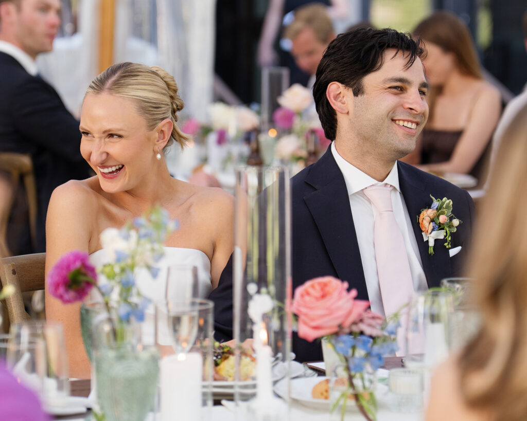 Bride and groom smiling together during their colorful wedding reception at Snowpine Lodge in Little Cottonwood Canyon, Utah.