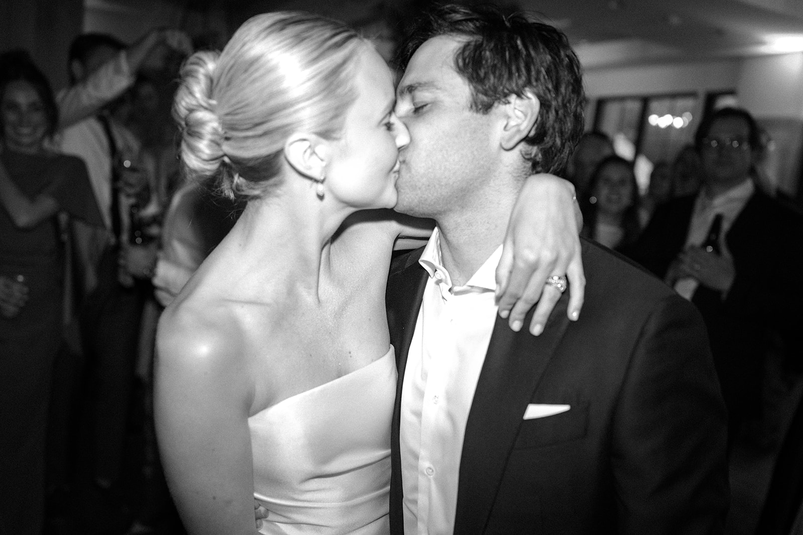 Black-and-white photograph of the bride and groom kissing on the dance floor during their Snowpine Lodge wedding reception.