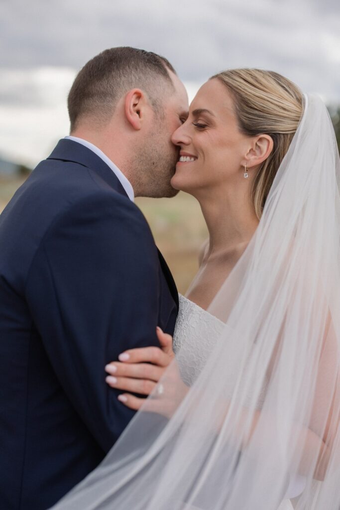 Close-up portrait of a smiling bride and groom during their wedding at Red Ledges Country Club in Heber, Utah.